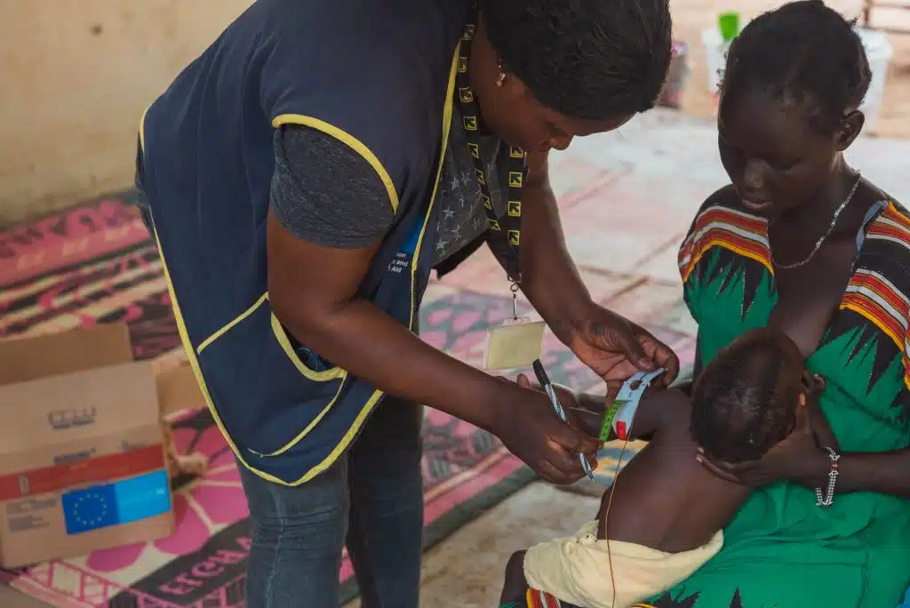 Dans le camp de réfugiés de Kakuma, au Kenya Sabina Naboi, mère d'Analia Wally, donne à sa fille des aliments thérapeutiques. Au Kenya, Six saisons de sécheresse sévère, accélérée par le changement climatique, ont eu un impact négatif sur l'état nutritionnel des habitants du comté de Turkana. © UNICEF/UNI431382/Kidero